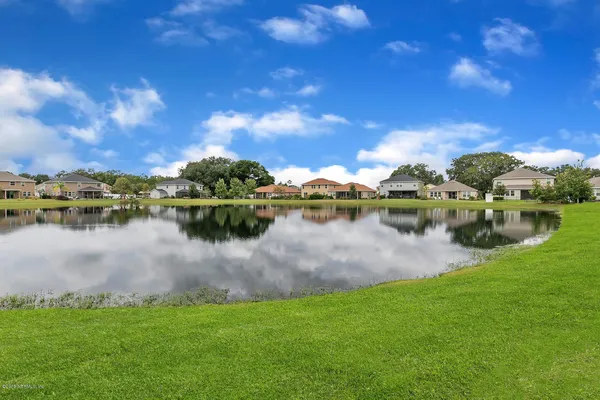 a view of a lake with houses in the background
