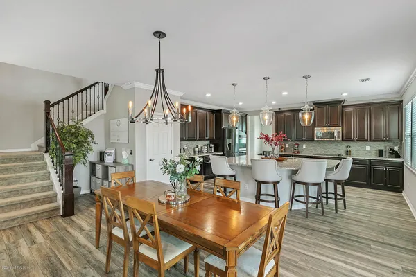 a dining room with furniture window and wooden floor