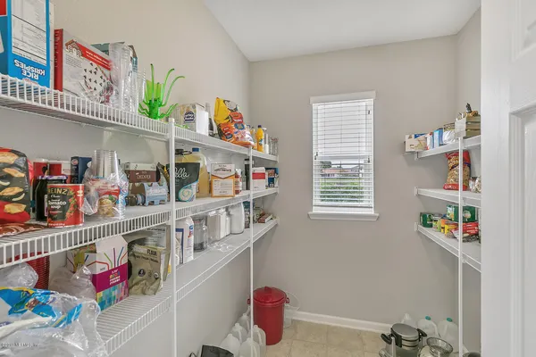 a kitchen with lots of clutter and cabinets