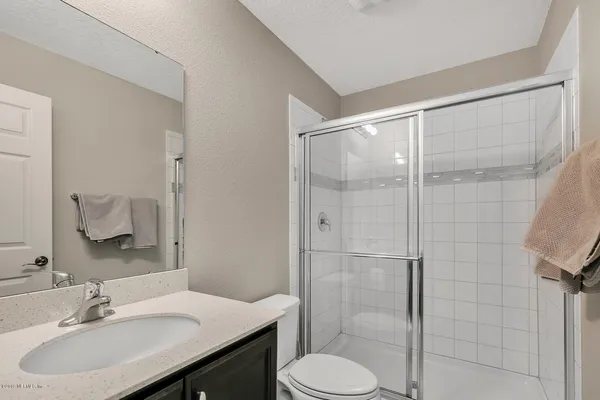 a bathroom with a sink toilet and shower