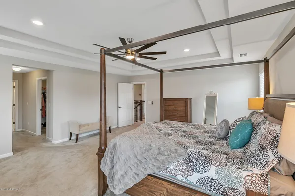a bedroom with a bed and a mirror