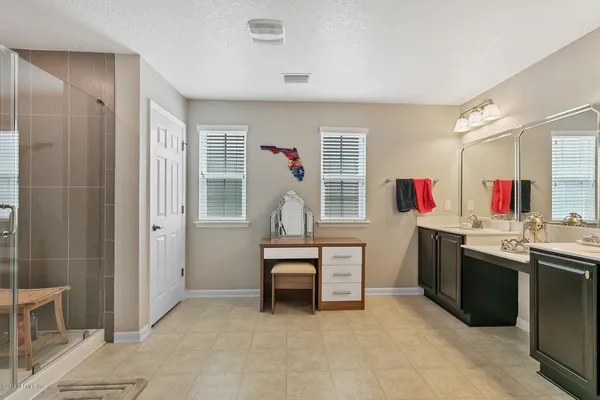a view of kitchen with sink refrigerator and cabinets