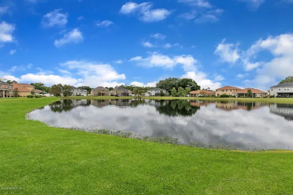 a view of a lake with houses in the back