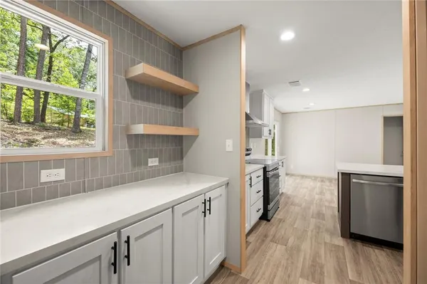 a kitchen that has a sink a stove and a refrigerator
