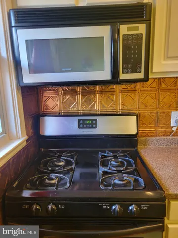 a stove top oven sitting inside of a kitchen