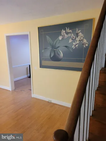 a view of a hallway with paintings on the wall