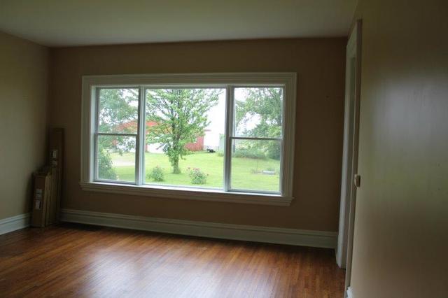 19567 Mathew Road Morrison, IL 61270 - Photo 36 of 62 a view of an empty room with wooden floor and a window