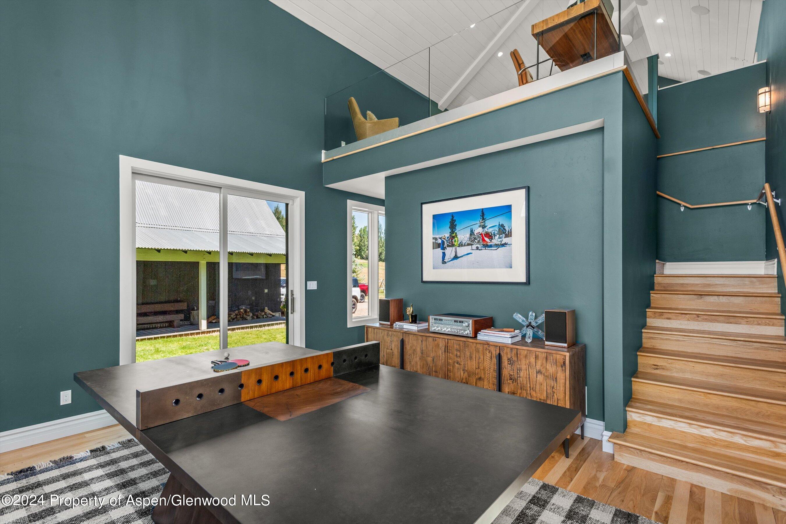 91 Alexander Avenue Snowmass, CO 81654 - Photo 17 of 32 a living room with furniture pool table and a large window