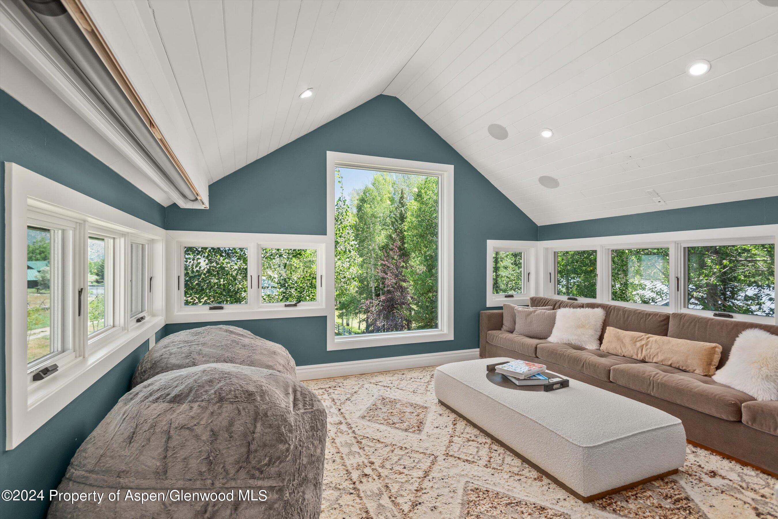 91 Alexander Avenue Snowmass, CO 81654 - Photo 18 of 32 a living room with furniture and a large window