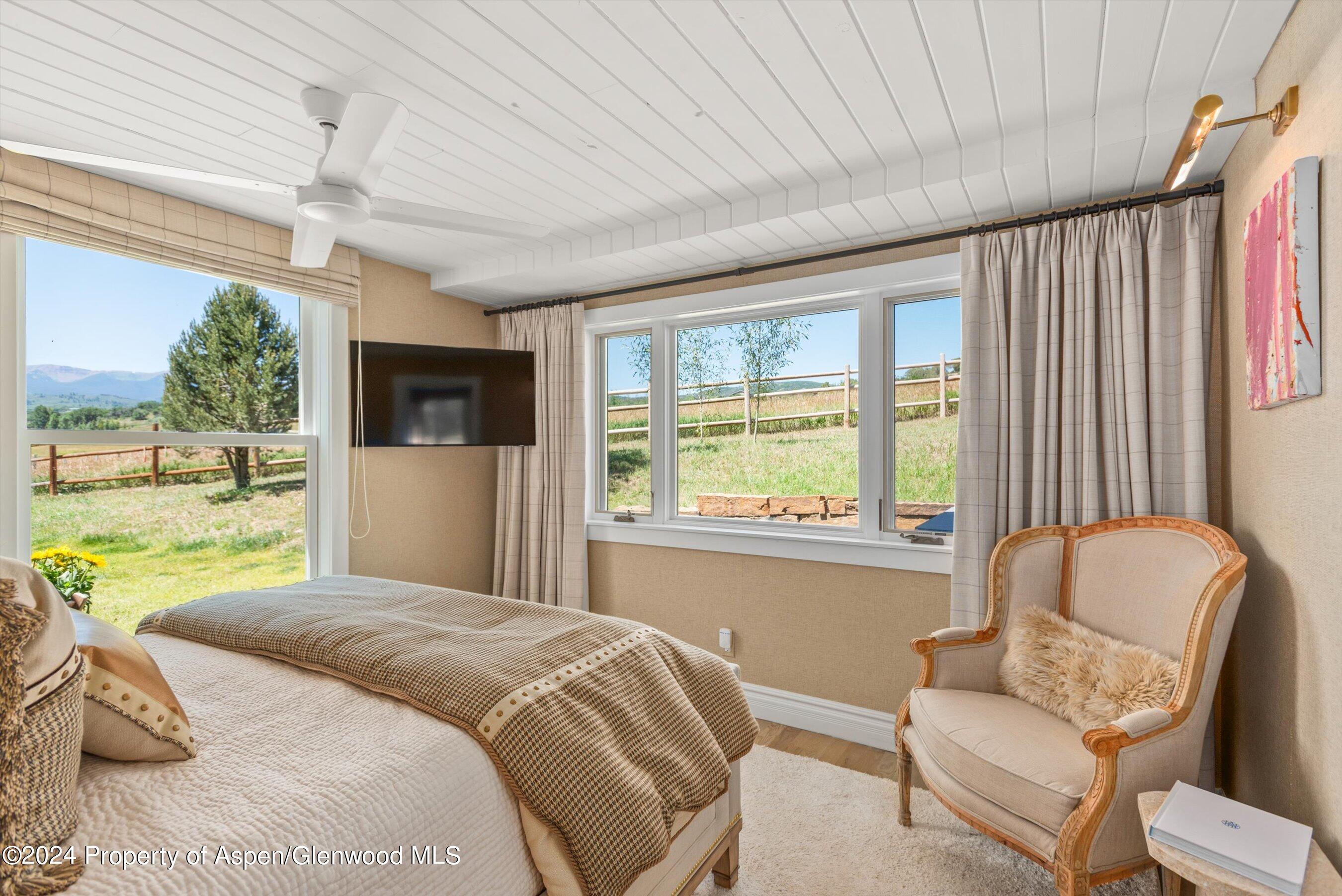 91 Alexander Avenue Snowmass, CO 81654 - Photo 21 of 32 a bedroom with a bed couch and window