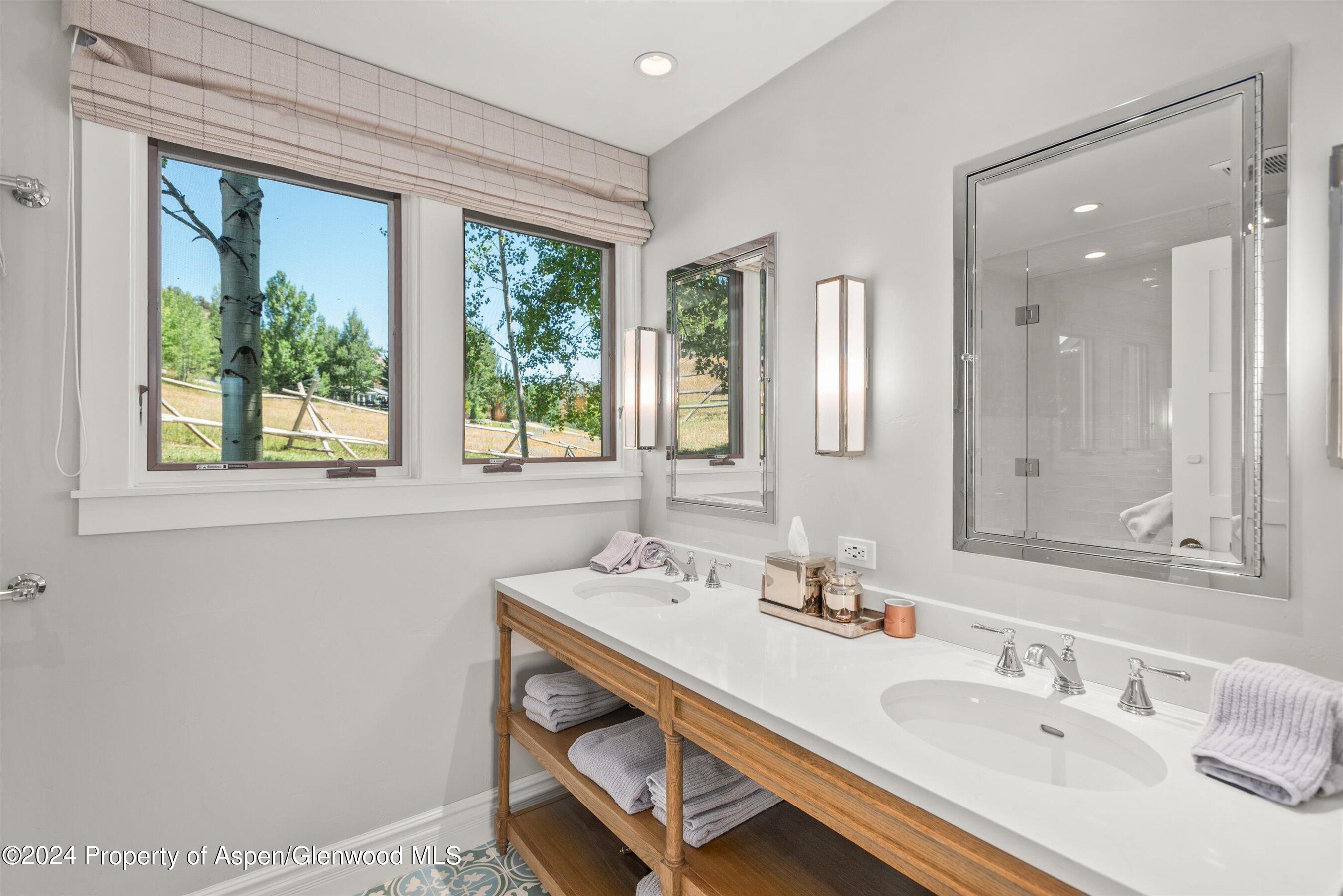 91 Alexander Avenue Snowmass, CO 81654 - Photo 22 of 32 a bathroom with a sink and a mirror