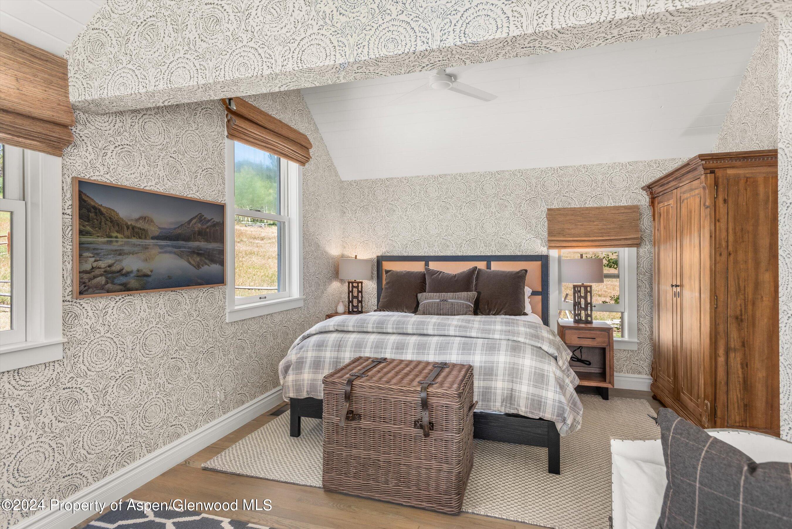 91 Alexander Avenue Snowmass, CO 81654 - Photo 23 of 32 a bedroom with a bed and large window