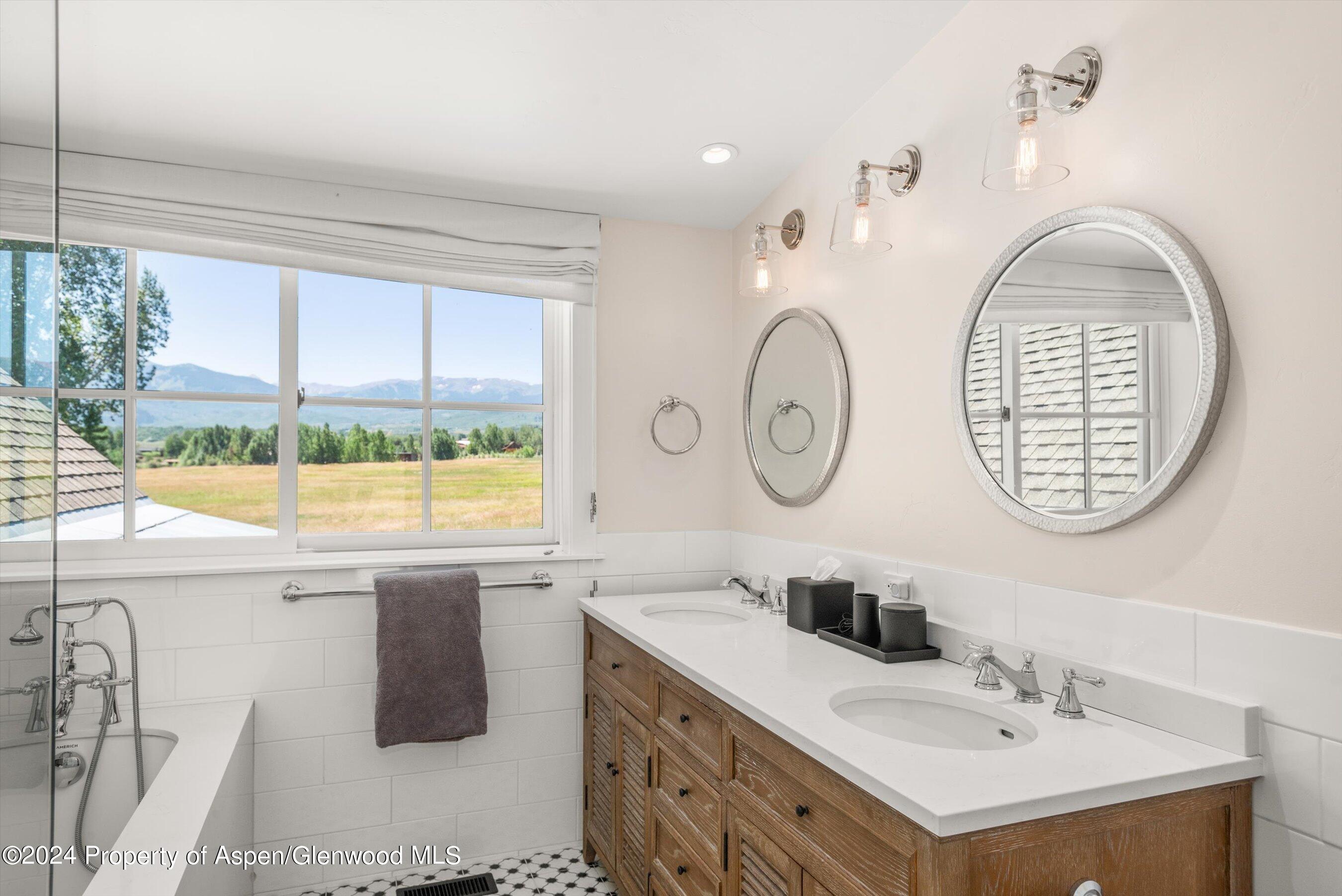 91 Alexander Avenue Snowmass, CO 81654 - Photo 26 of 32 a bathroom with a sink and a mirror