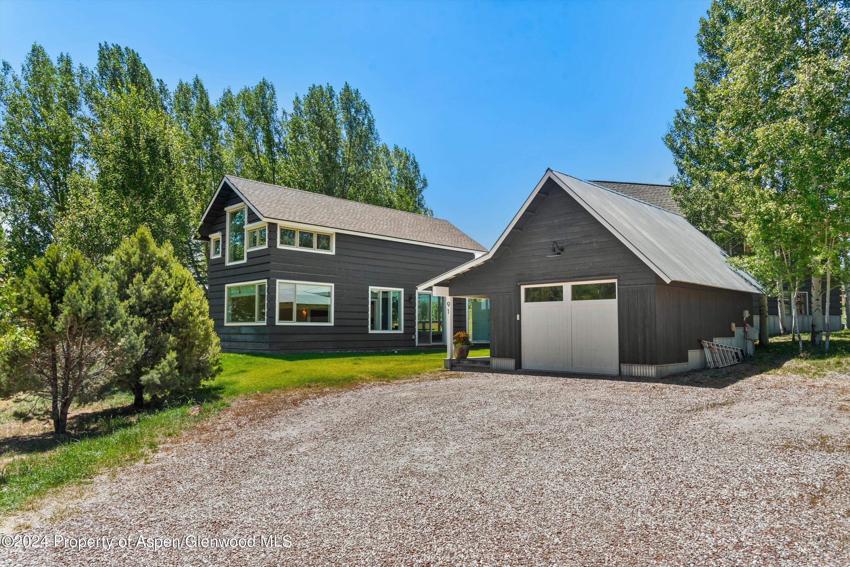 91 Alexander Avenue Snowmass, CO 81654 - Photo 32 of 32 a front view of a house with a yard and garage
