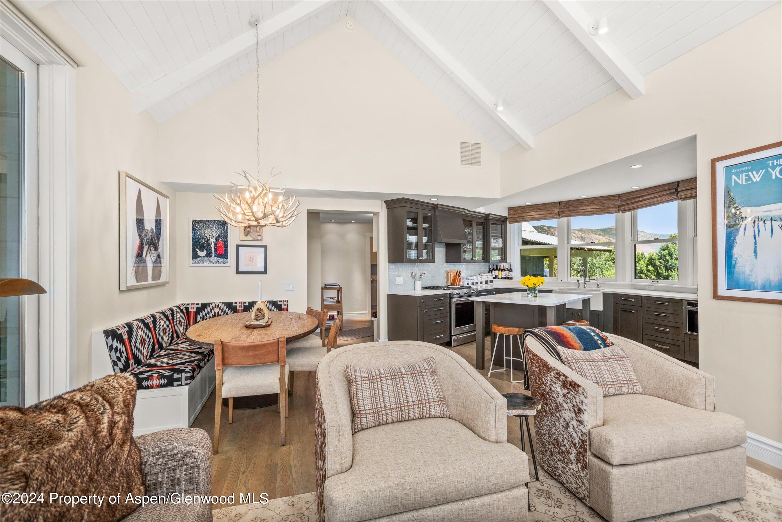 91 Alexander Avenue Snowmass, CO 81654 - Photo 6 of 32 a living room with furniture kitchen view and large windows