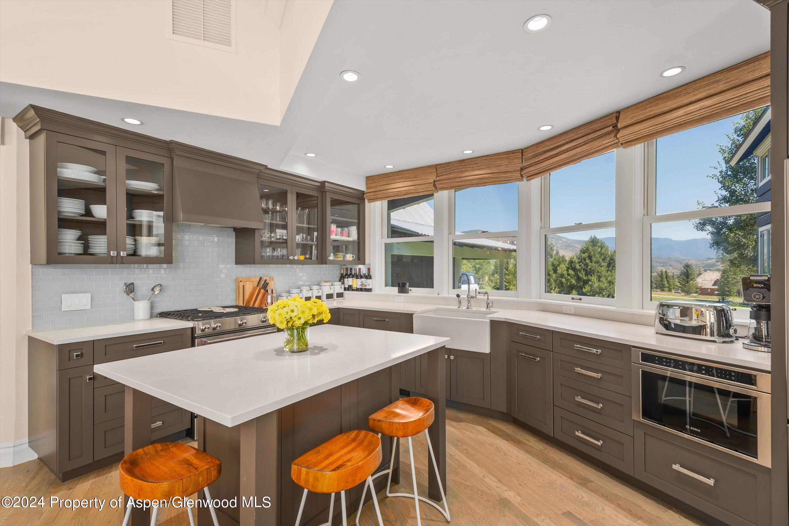 91 Alexander Avenue Snowmass, CO 81654 - Photo 9 of 32 a kitchen with a sink a counter and chairs