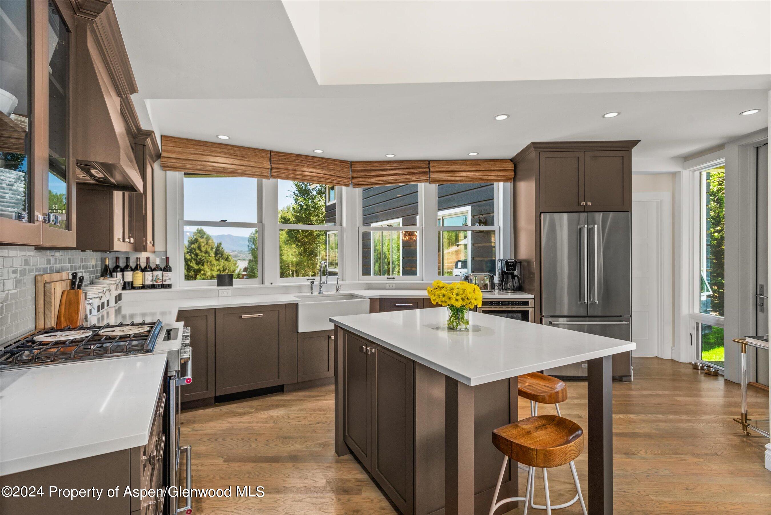 91 Alexander Avenue Snowmass, CO 81654 - Photo 10 of 32 a kitchen with a sink stove and cabinets
