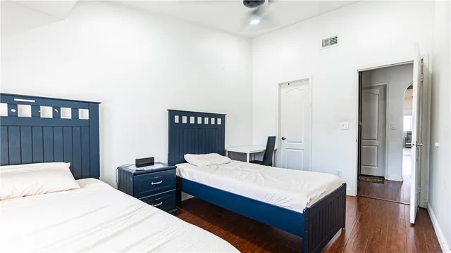 a view of a white house with large windows and a table and chairs