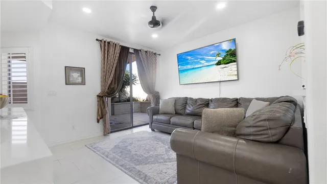 a living room with furniture ceiling fan and a rug