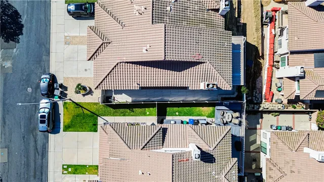 an aerial view of residential houses with outdoor space