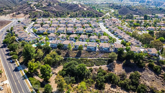 an aerial view of multiple houses with yard