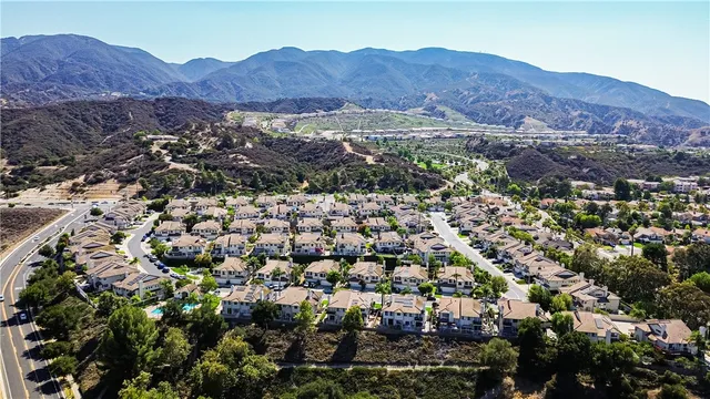 an aerial view of multiple houses with yard
