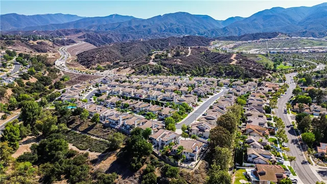 an aerial view of a house with garden space and street view