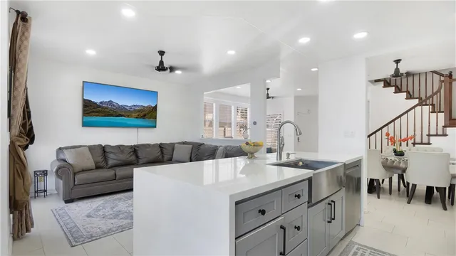 a living room with furniture and kitchen view