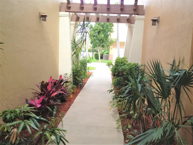 a vase of flowers sitting on a floor in front of a door