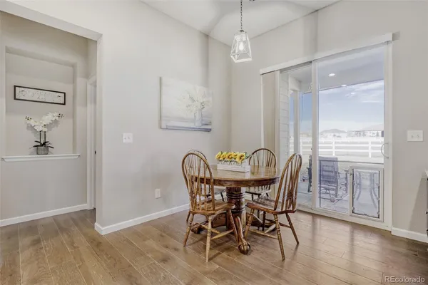 a view of a dining room with furniture window and wooden floor