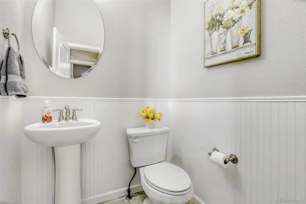 a bathroom with a sink mirror toilet and a mirror