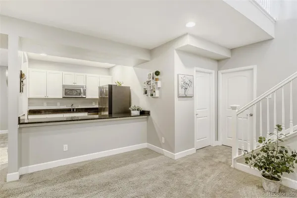 a kitchen with stainless steel appliances a refrigerator and a stove top oven