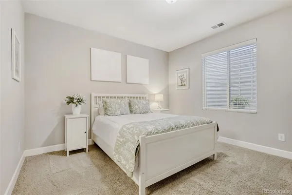 a spacious bedroom with a bed and a window