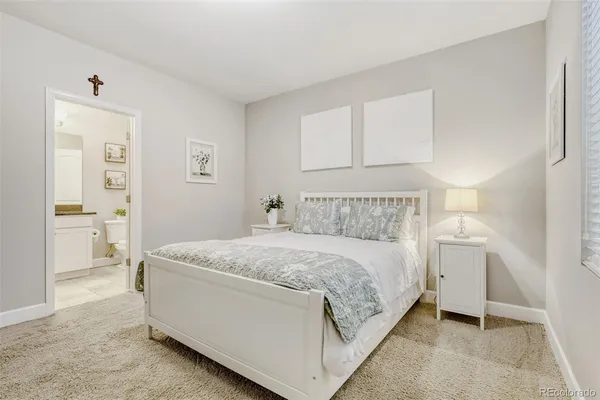 a bedroom with a bed and a lamp