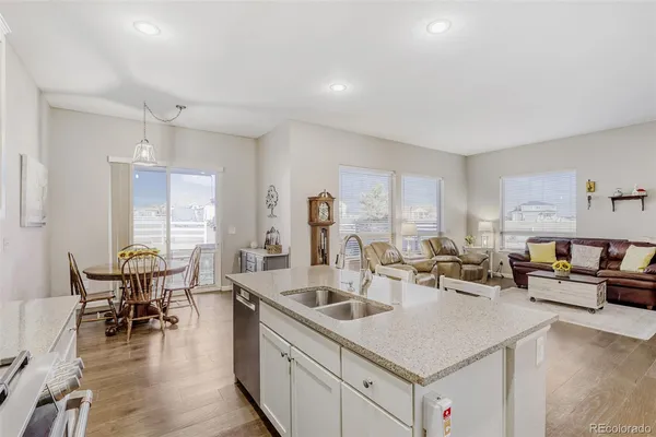a kitchen with sink refrigerator and dining table