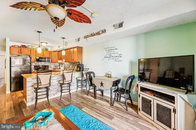 a living room with dining room and wooden floor