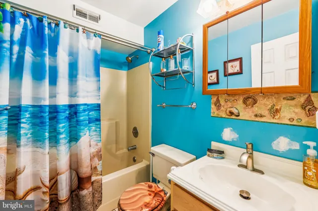 a bathroom with a sink mirror and a bathtub
