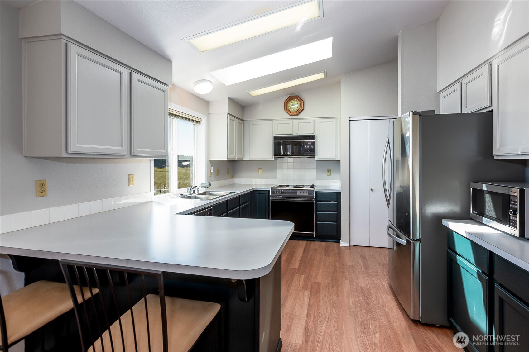 549 Davis Bay Road Lopez Island, WA 98261 - Photo 15 of 37 a kitchen with a sink a kitchen island and stainless steel appliances