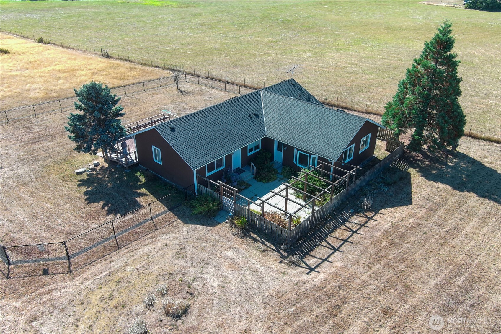 549 Davis Bay Road Lopez Island, WA 98261 - Photo 2 of 37 a roof deck with table and chairs with wooden floor and fence
