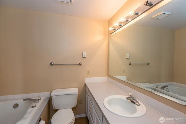 a bathroom with a sink a toilet and a mirror