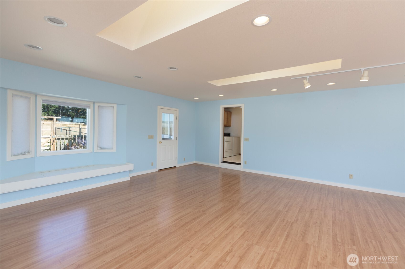 549 Davis Bay Road Lopez Island, WA 98261 - Photo 25 of 37 an empty room with wooden floor and windows