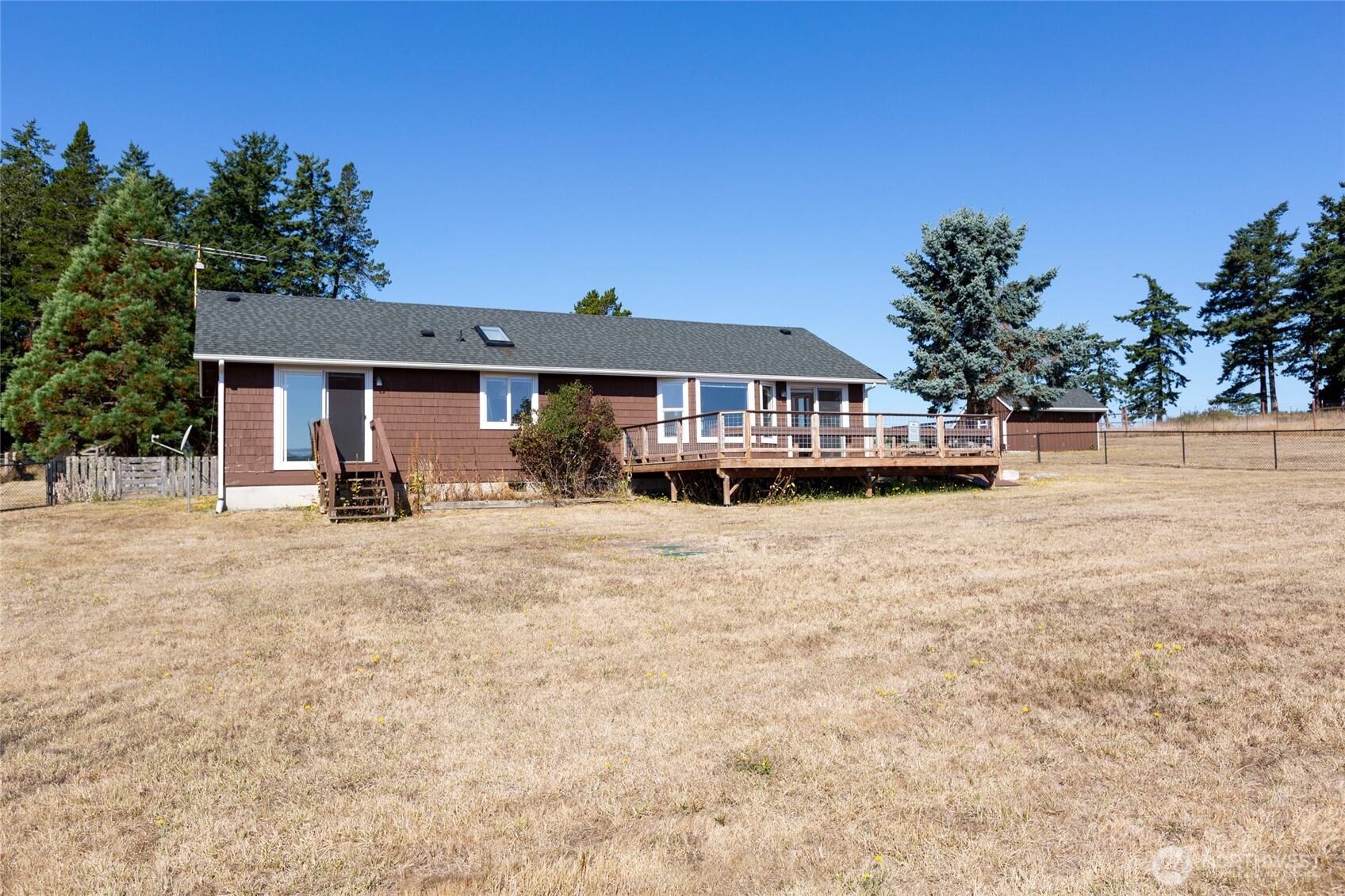 549 Davis Bay Road Lopez Island, WA 98261 - Photo 4 of 37 a front view of a house with a yard