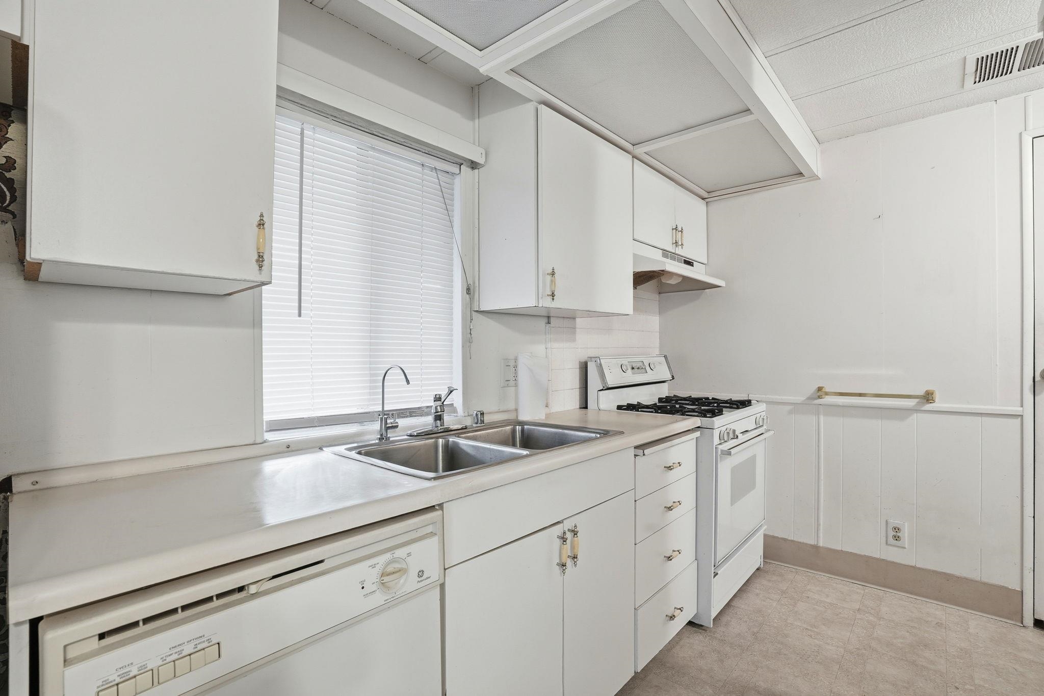4603 Balfour Road, Unit 12 Brentwood, CA 94513 - Photo 11 of 36 a kitchen with white cabinets and a sink