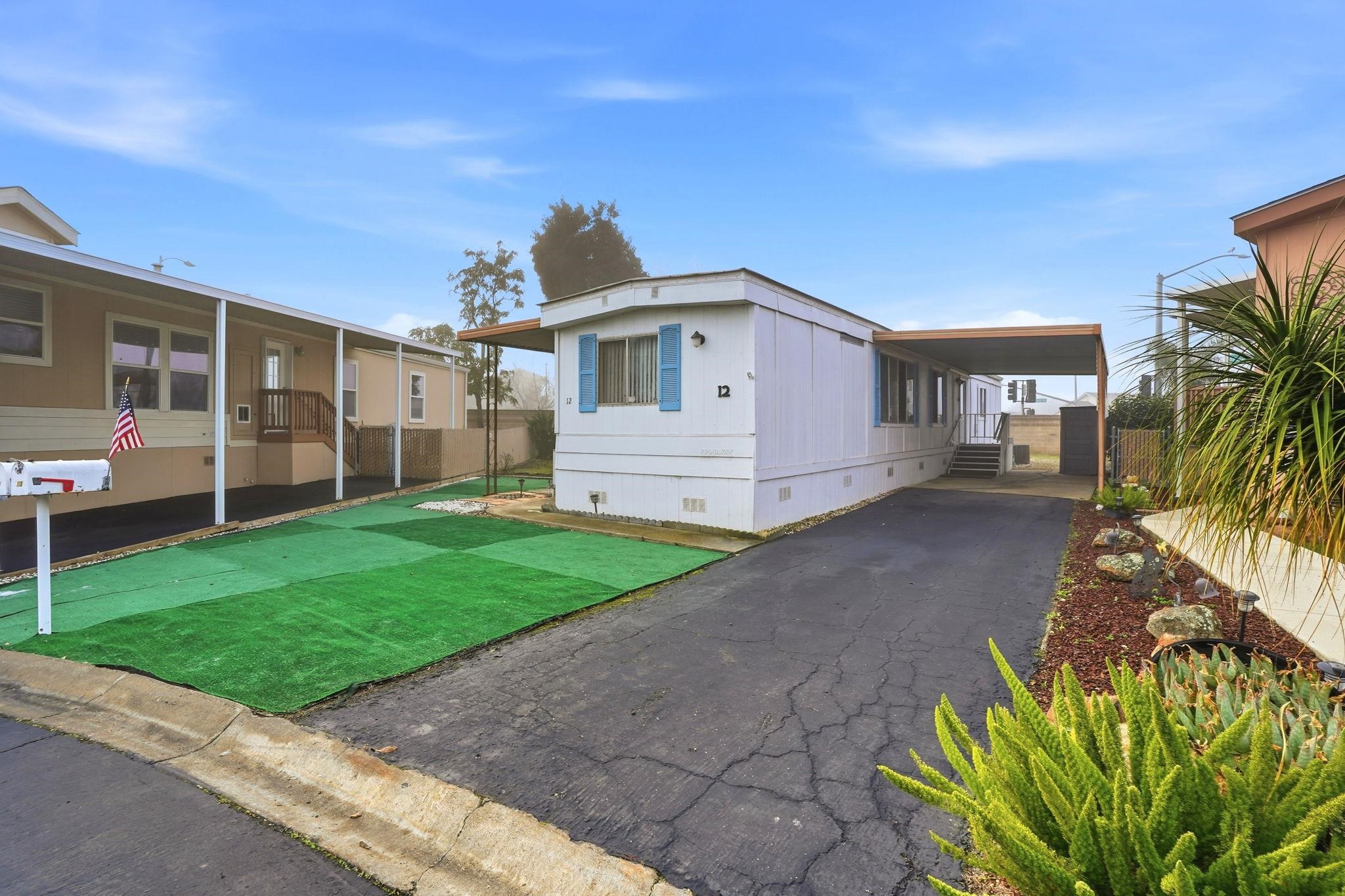 4603 Balfour Road, Unit 12 Brentwood, CA 94513 - Photo 2 of 36 a front view of a house with a garden and yard