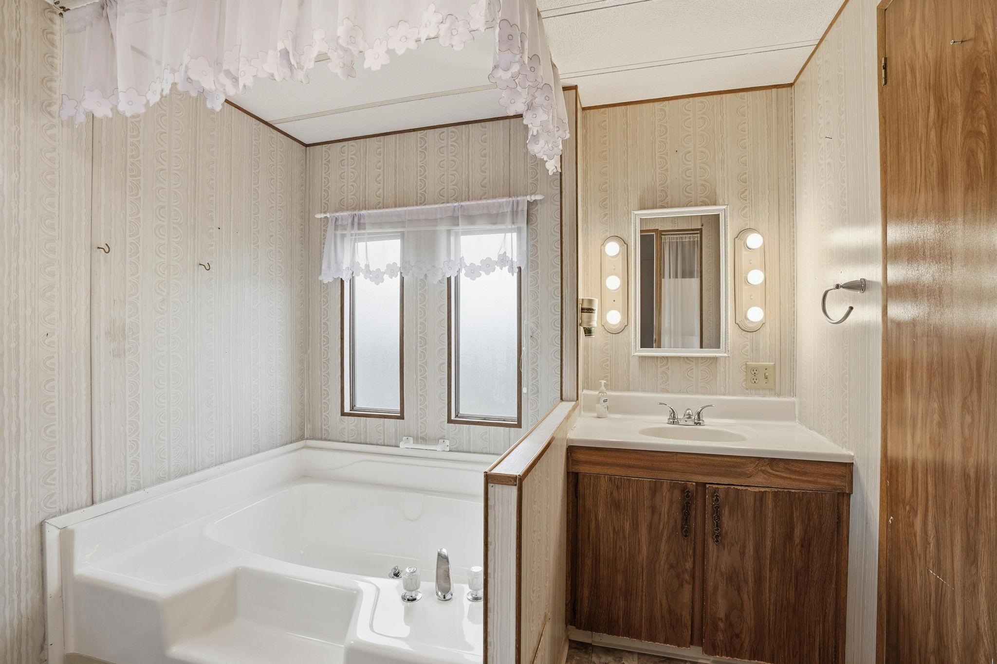 4603 Balfour Road, Unit 12 Brentwood, CA 94513 - Photo 22 of 36 a bathroom with a tub sink and mirror
