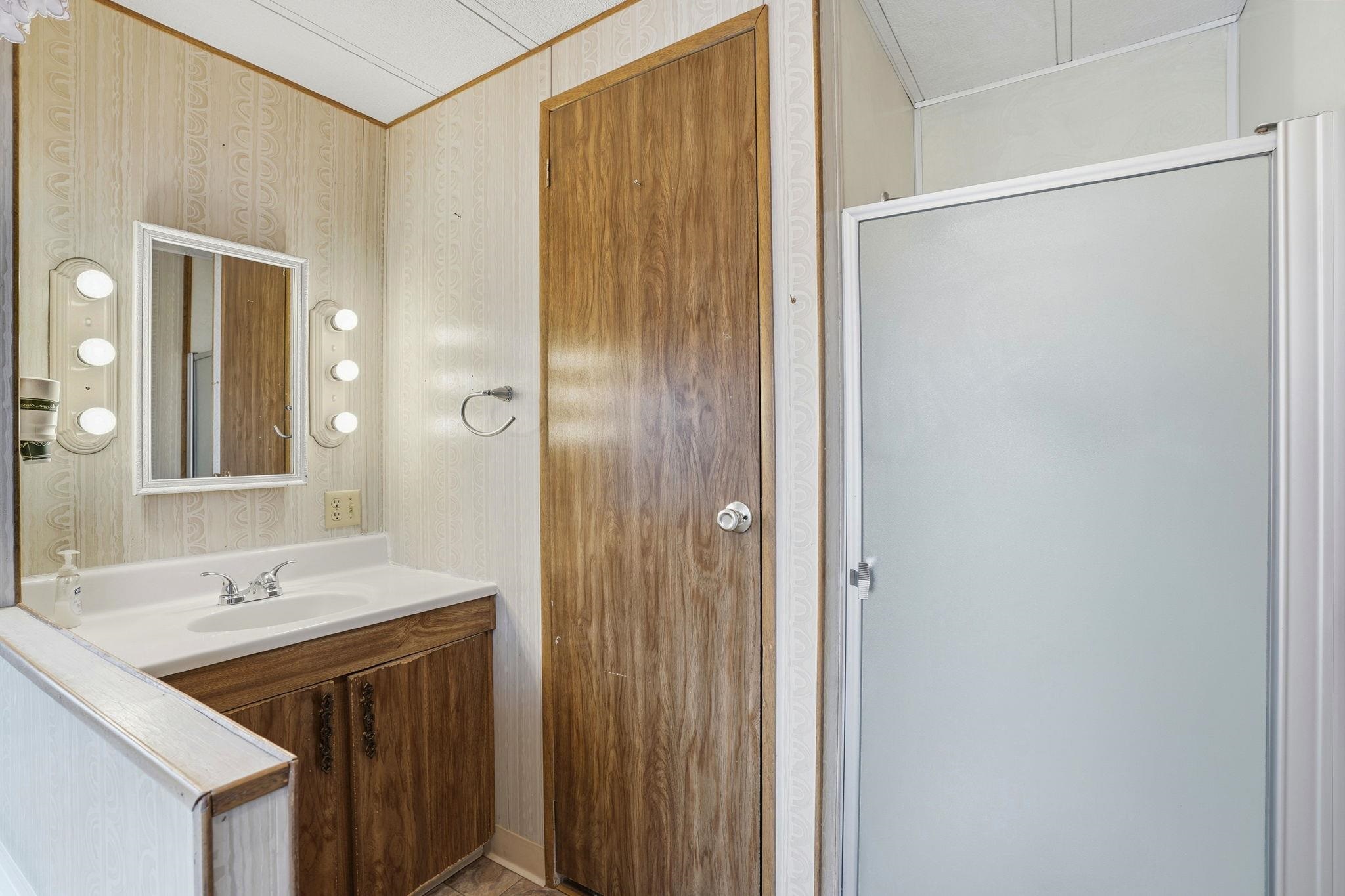 4603 Balfour Road, Unit 12 Brentwood, CA 94513 - Photo 24 of 36 a bathroom with a double vanity sink and mirror