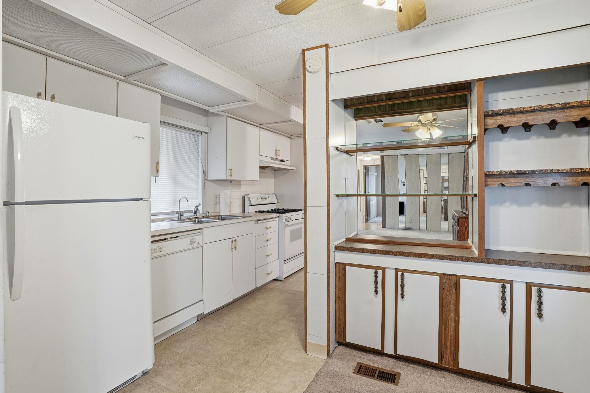 4603 Balfour Road, Unit 12 Brentwood, CA 94513 - Photo 10 of 36 a kitchen with white cabinets and refrigerator