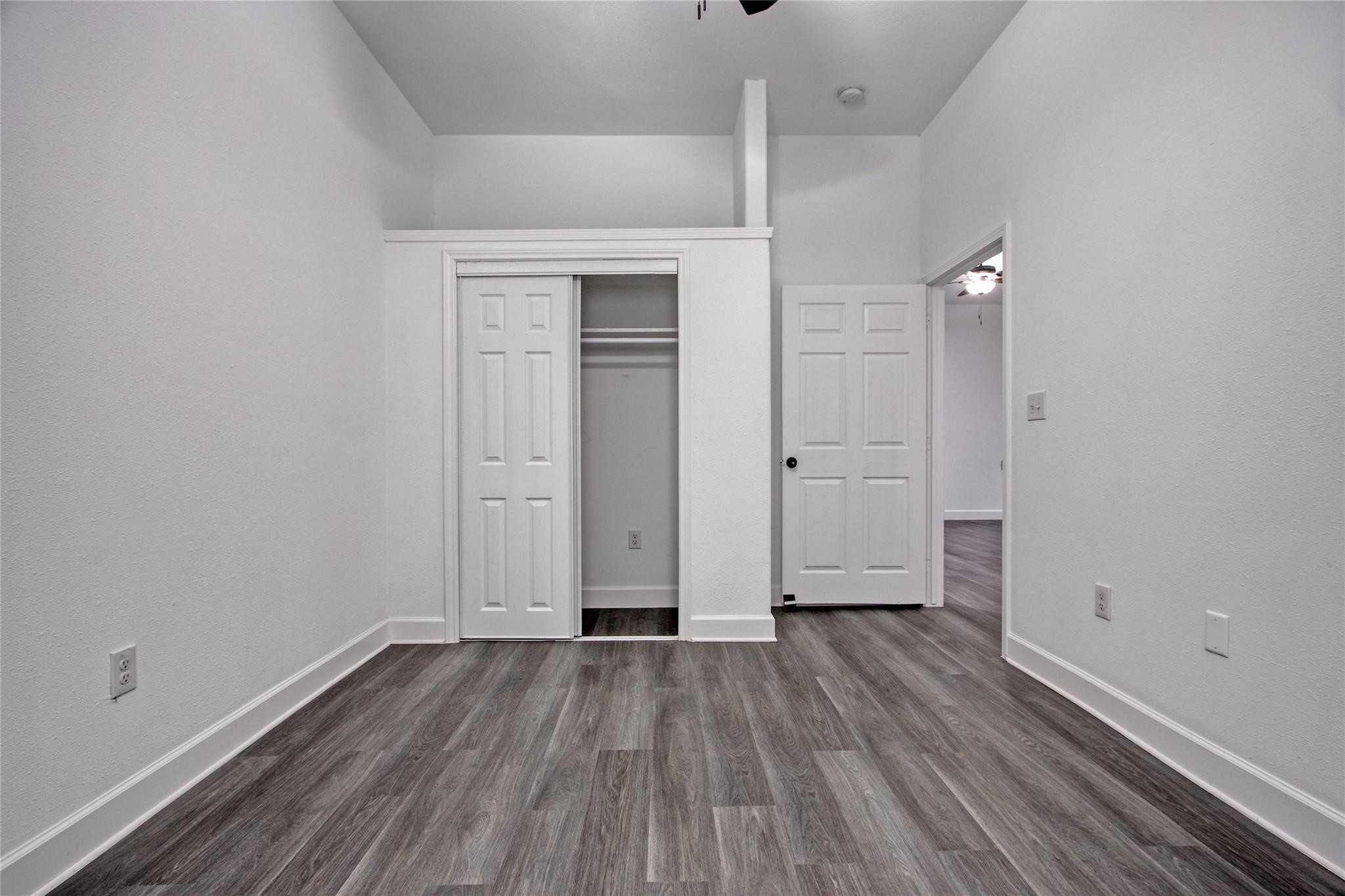 14310 Sweeney Road Houston, TX 77060 - Photo 10 of 14 an empty room with wooden floor and windows