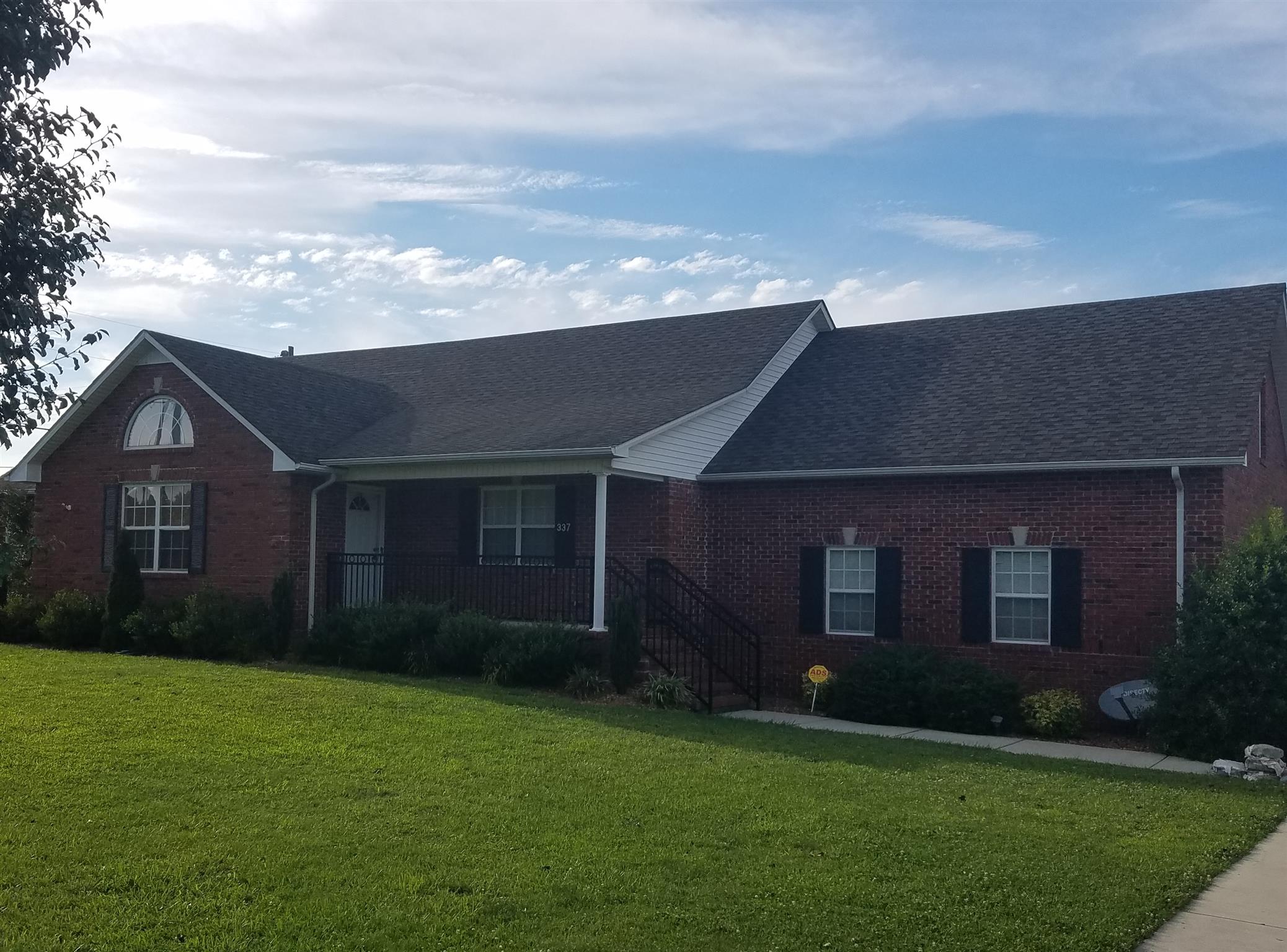337 Brandon Road Manchester, TN 37355 - Photo 15 of 16 a backyard of a house with lots of green space and garden