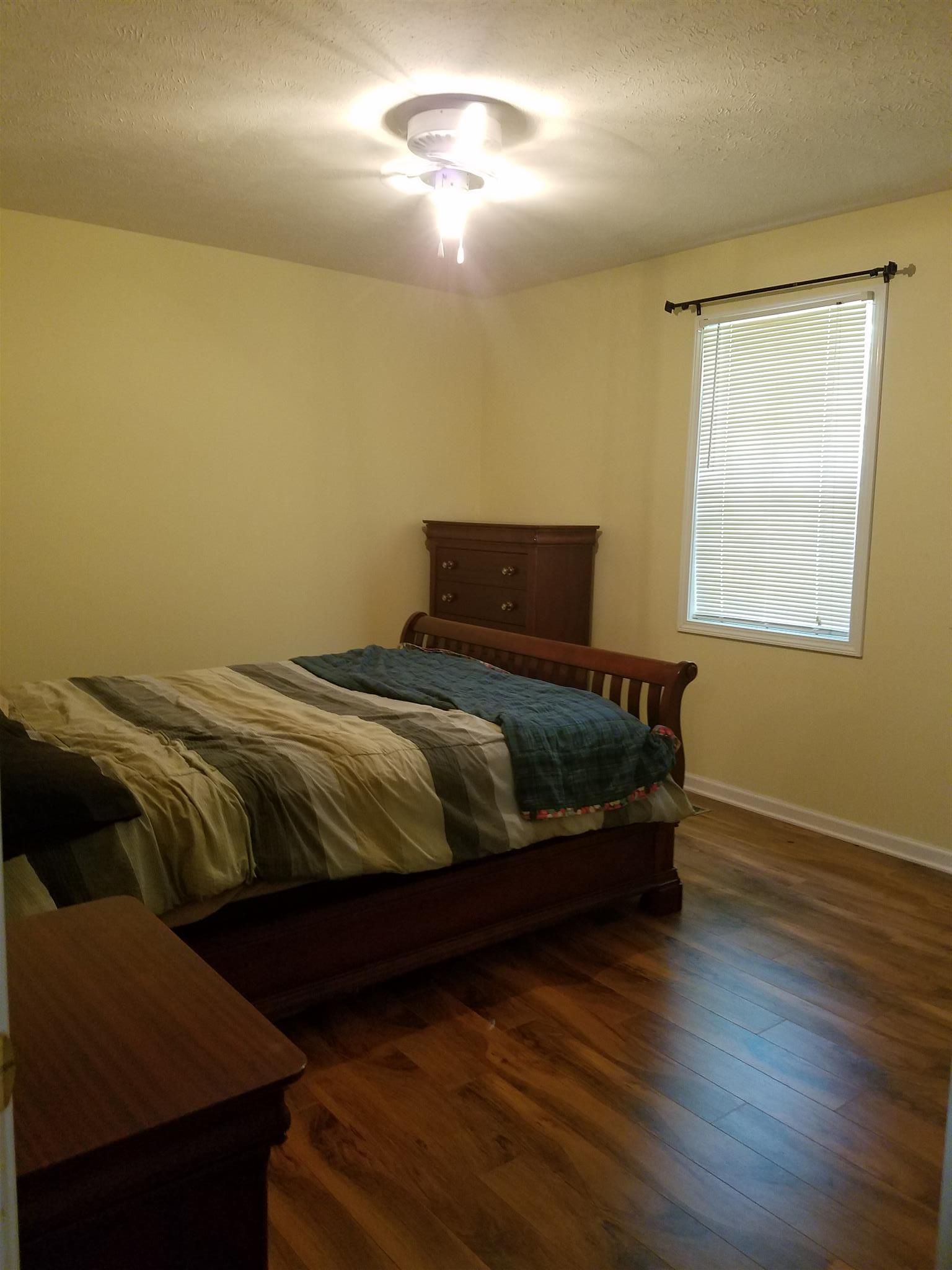 337 Brandon Road Manchester, TN 37355 - Photo 4 of 16 a bedroom with a bed and wooden floor
